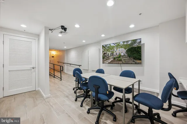 a view of a dining room with furniture and a potted plant