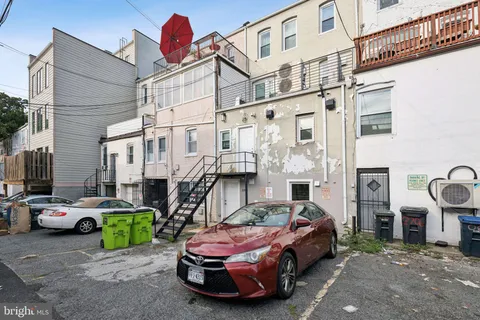 a view of a cars park in front of a building