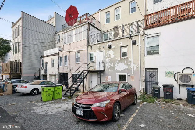 a view of a cars park in front of a building