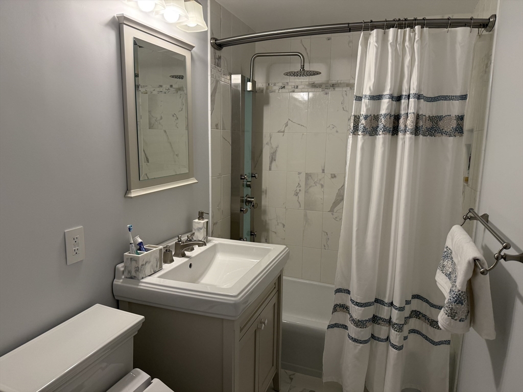 5 Porter Road, Unit 202 Andover, MA 01810 - Photo 9 of 17 a bathroom with a sink and mirror with toilet