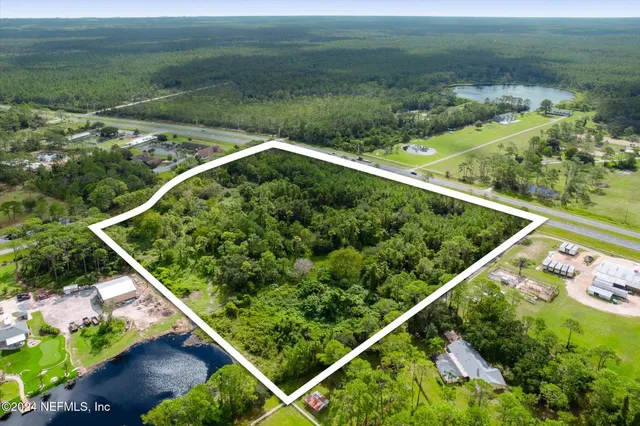 a view of a yard with wooden fence