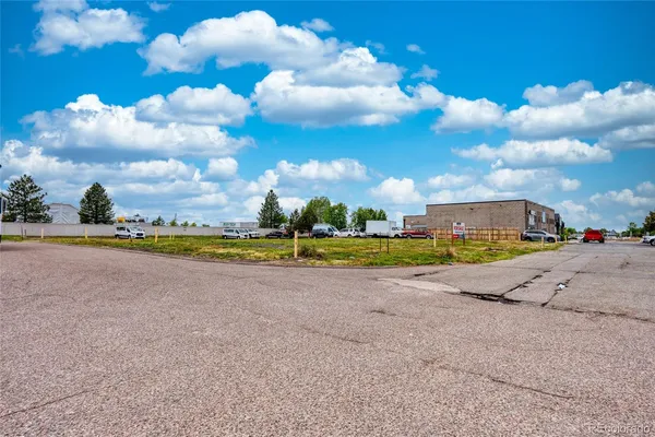 a view of a house with a big yard and large trees