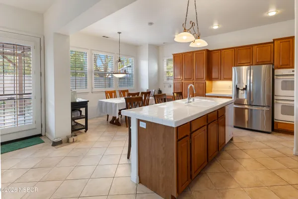 a kitchen with granite countertop a sink a counter top space appliances and cabinets