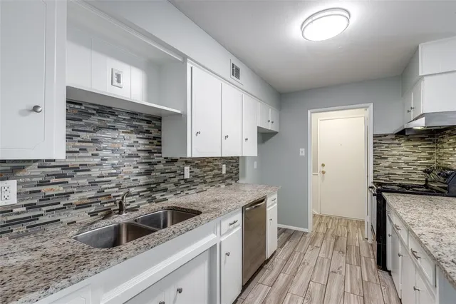 a kitchen that has a sink and a stove