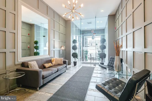 a living room with furniture fireplace and a chandelier