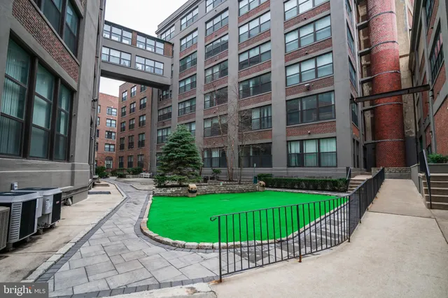 a view of a brick building next to a yard