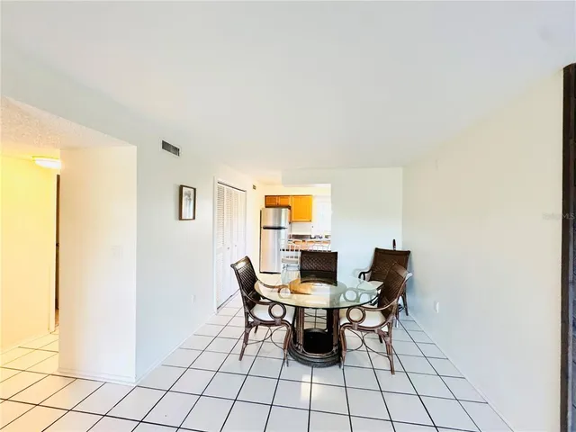 a bedroom with a bed and a lamp on a dresser