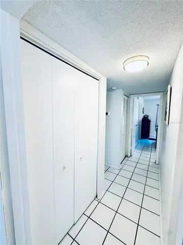 a view of a swimming pool with a lawn chairs and a fire pit