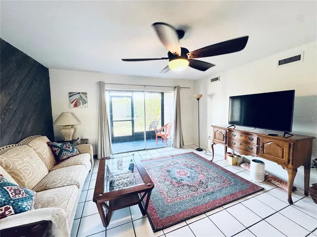 a view of a room with wooden floor and a hallway
