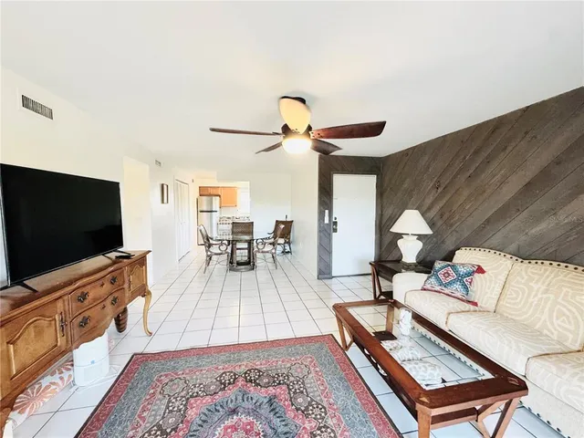 a dining room with furniture and a kitchen view