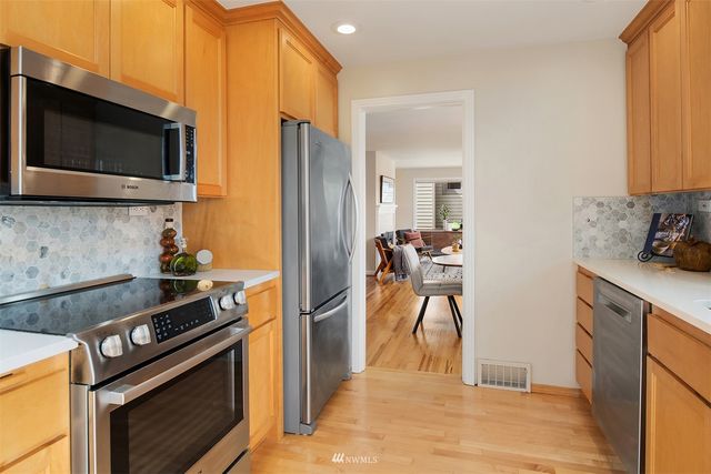a kitchen with stainless steel appliances a stove a microwave and a refrigerator