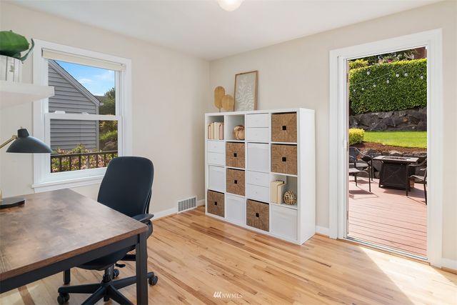 a view of a workspace with furniture and a window