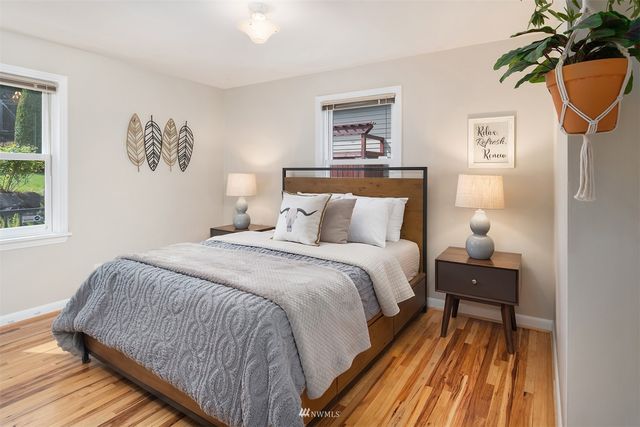 a bedroom with a bed and a lamp on table