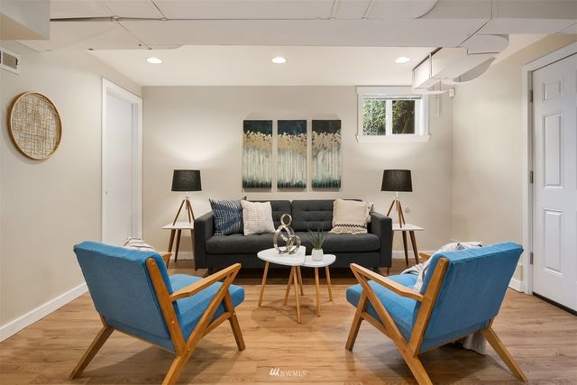a living room with furniture kitchen view and a window