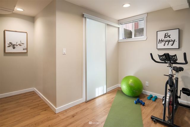 a view of a room with wooden floor and a window