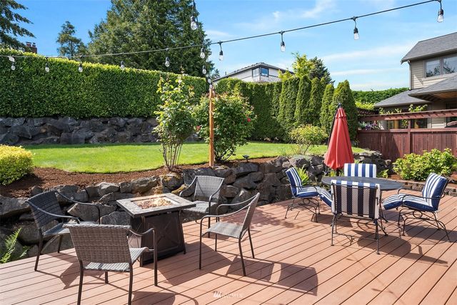 a view of a patio with table and chairs potted plants and palm tree