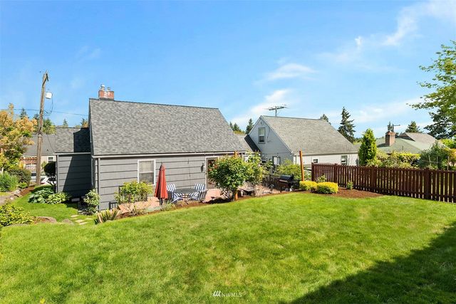a view of a house with a yard and sitting area