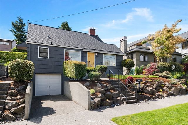 a view of a chairs and table in the backyard