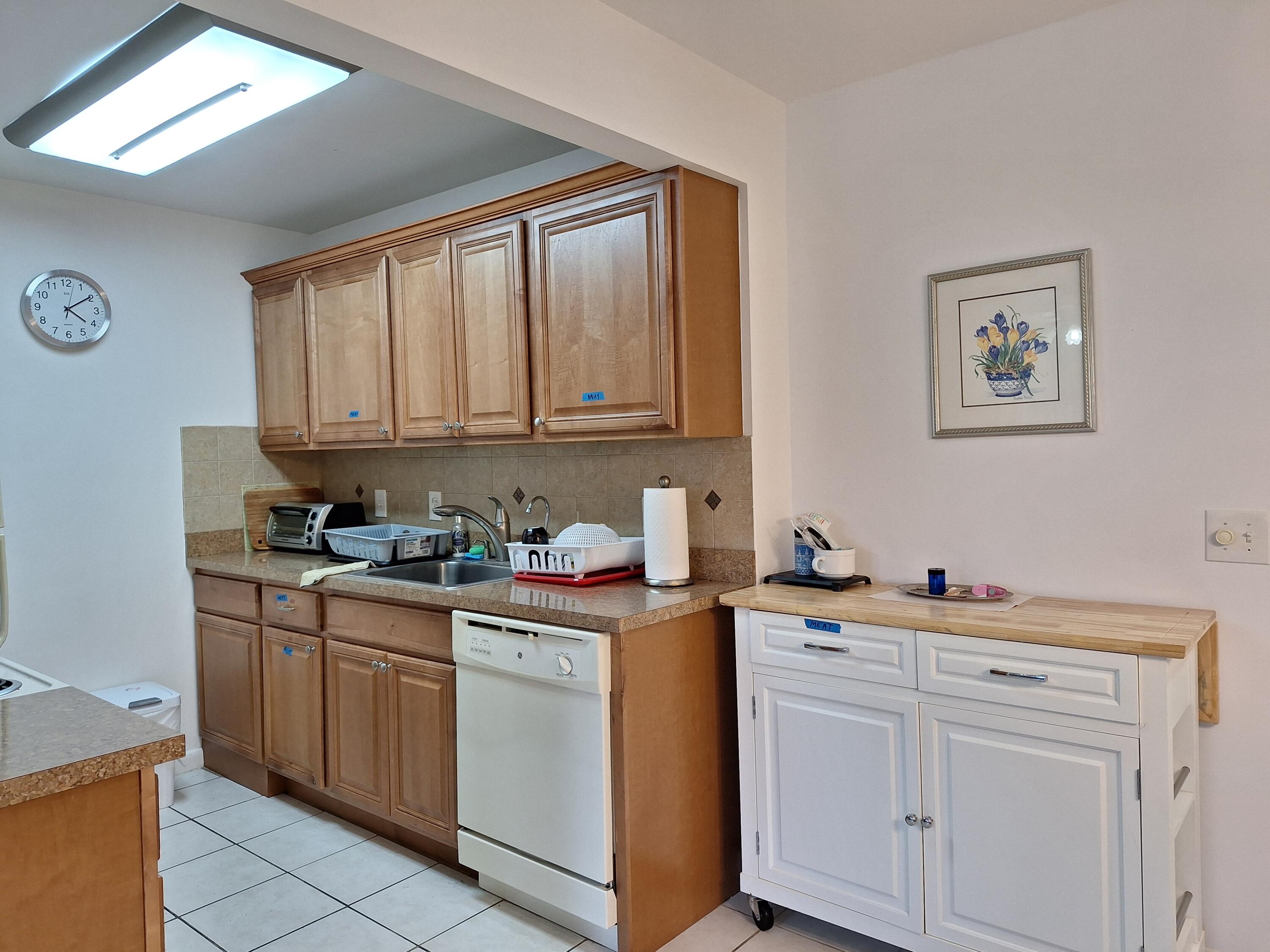 1010 Wolverton East Boca Raton, FL 33434 - Photo 6 of 30 a kitchen with a sink cabinets and window