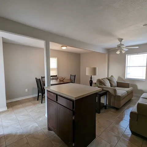 a view of living room filled with furniture and window