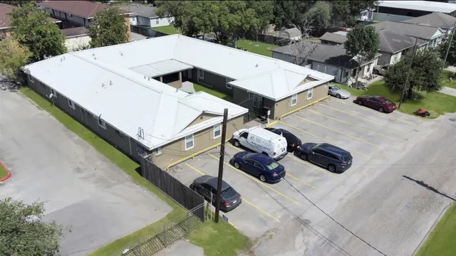 an aerial view of a house with swimming pool and patio