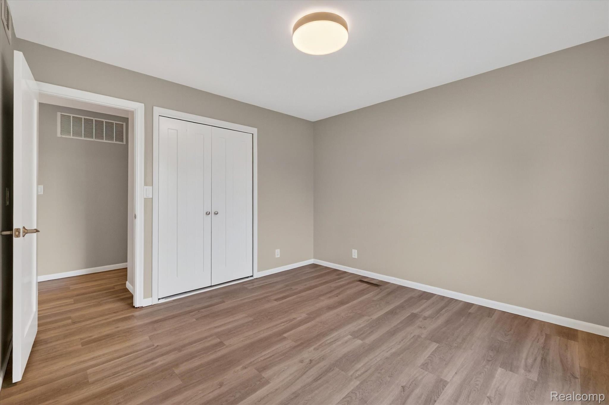 2264 Crane Road Fenton, MI 48430 - Photo 33 of 55 Unfurnished bedroom with light wood-style floors and a closet