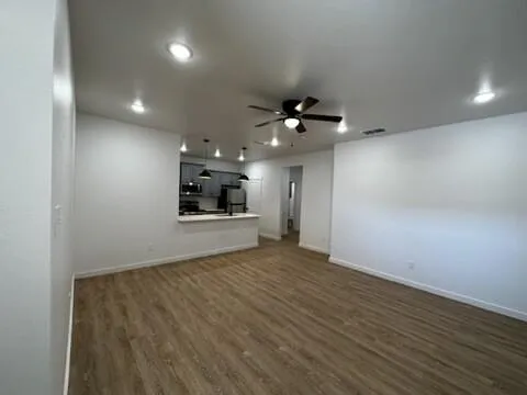 a view of a kitchen with a sink and refrigerator