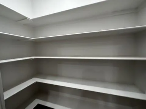 a view of storage and utility room with wooden floor