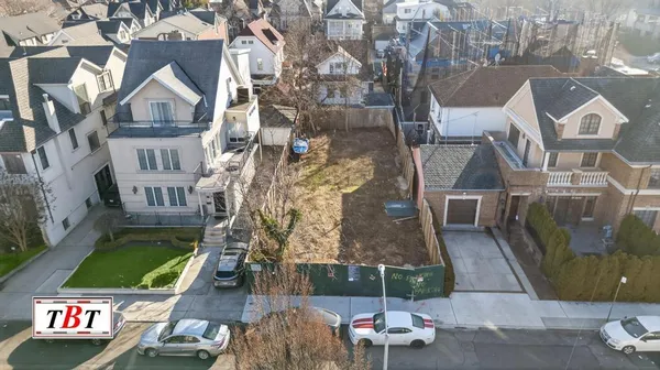 an aerial view of multiple houses with a yard