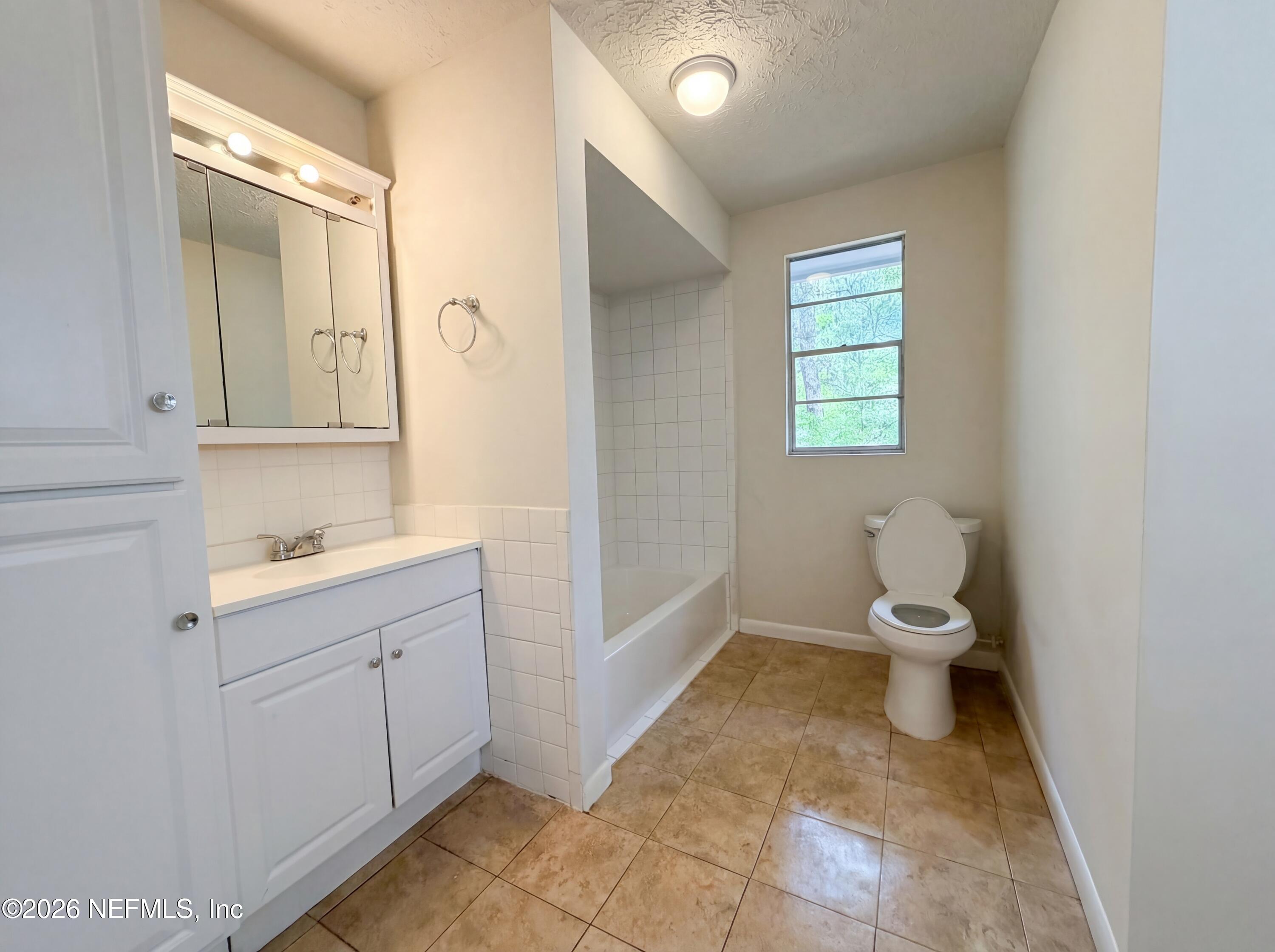 6917 Gatorbone Road Keystone Heights, FL 32656 - Photo 20 of 24 a bathroom with a toilet sink and mirror