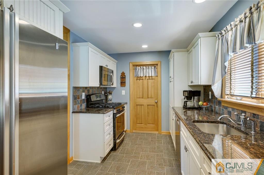 15 Carpender Road New Brunswick, NJ 08901 - Photo 11 of 25 a kitchen with granite countertop a refrigerator stove and sink