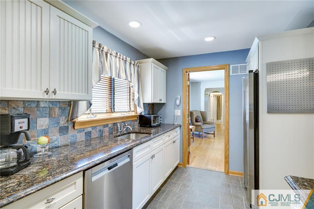 15 Carpender Road New Brunswick, NJ 08901 - Photo 12 of 25 a kitchen with granite countertop a sink a counter top space cabinets and stainless steel appliances