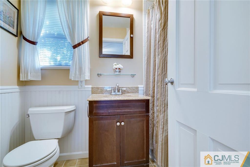 15 Carpender Road New Brunswick, NJ 08901 - Photo 14 of 25 a bathroom with a toilet a sink and mirror