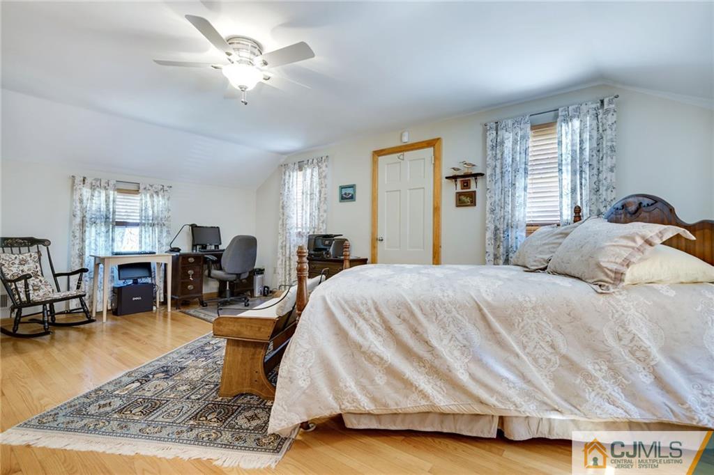15 Carpender Road New Brunswick, NJ 08901 - Photo 17 of 25 a spacious bedroom with a bed a table and chair