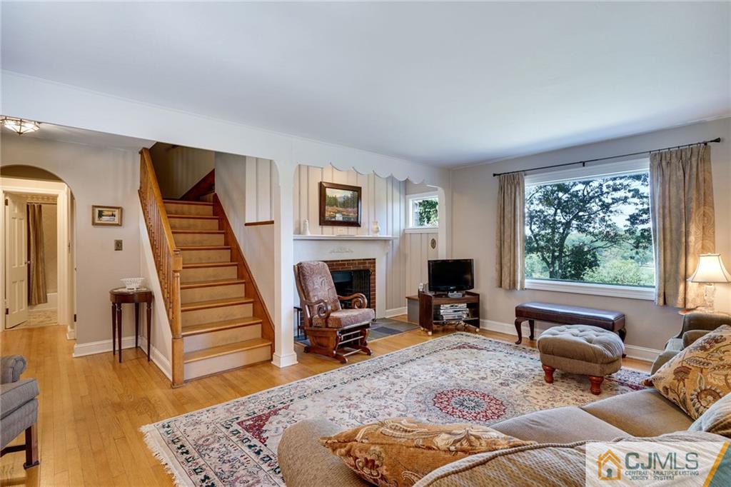 15 Carpender Road New Brunswick, NJ 08901 - Photo 7 of 25 a living room with furniture fireplace and wooden floor