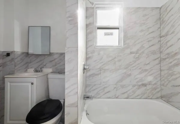 a bathroom with a toilet a sink and a window