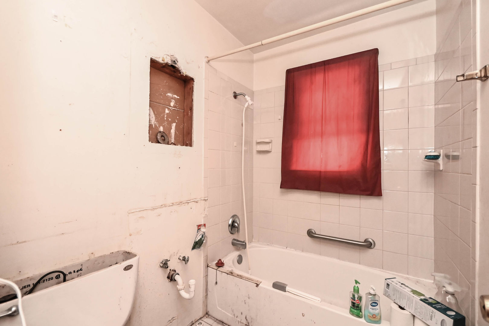 629 Fulton Avenue Waukegan, IL 60085 - Photo 9 of 25 a bathroom with a sink a toilet and shower curtain