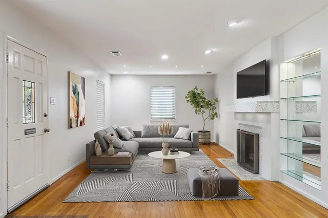 a living room with furniture fireplace and flat screen tv