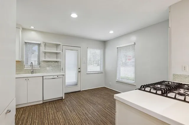 a kitchen with a sink stove and cabinets