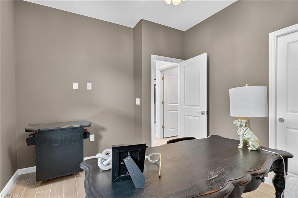 1657 Serena Avenue Naples, FL 34120 - Photo 13 of 40 a workspace with furniture and bathroom