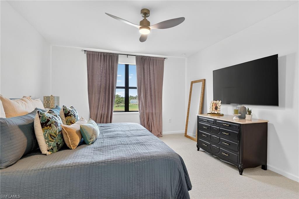 1657 Serena Avenue Naples, FL 34120 - Photo 17 of 40 a bedroom with a bed and a flat screen tv