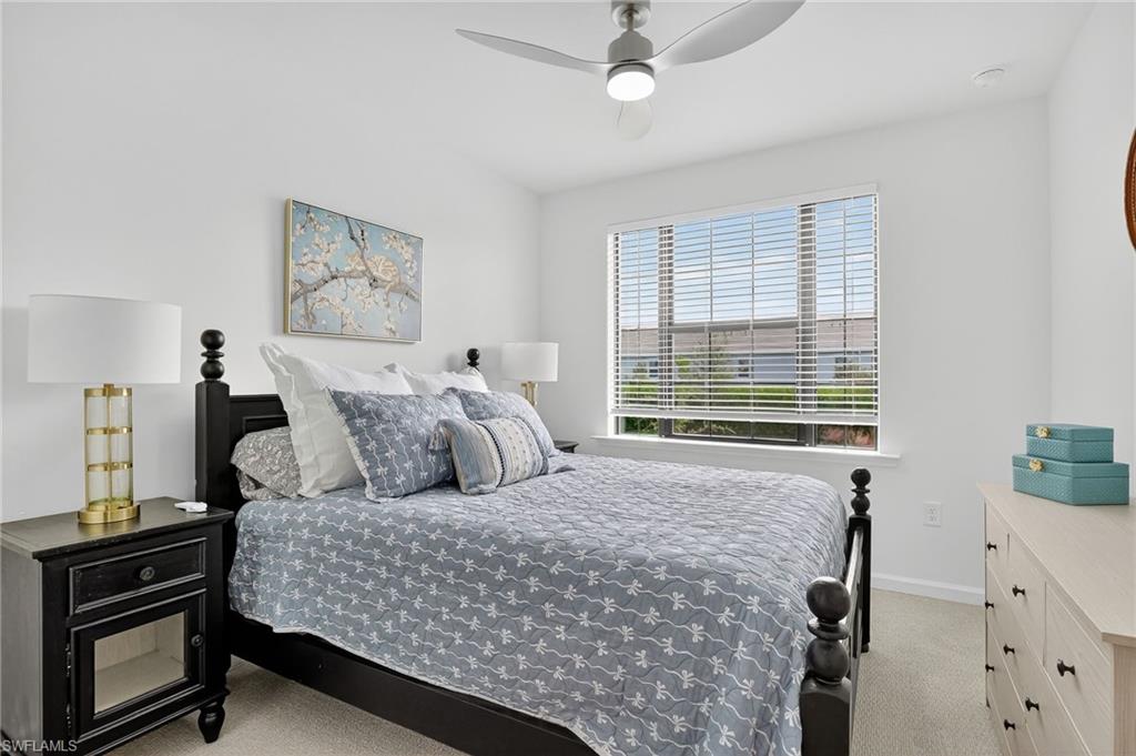 1657 Serena Avenue Naples, FL 34120 - Photo 24 of 40 a bedroom with a bed and a window