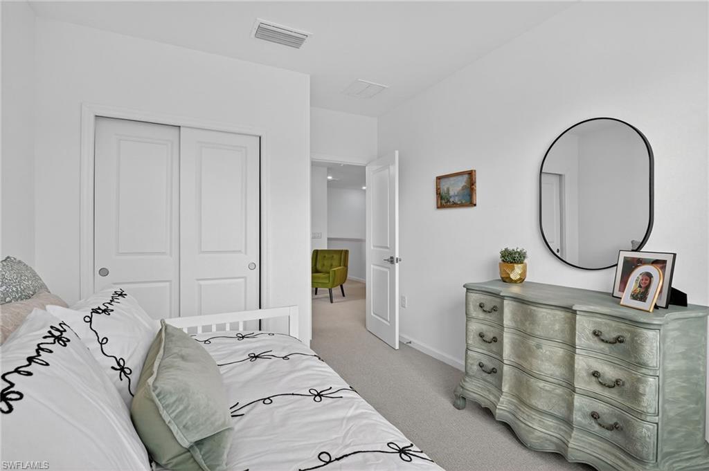 1657 Serena Avenue Naples, FL 34120 - Photo 26 of 40 a bedroom with a bed and a dresser