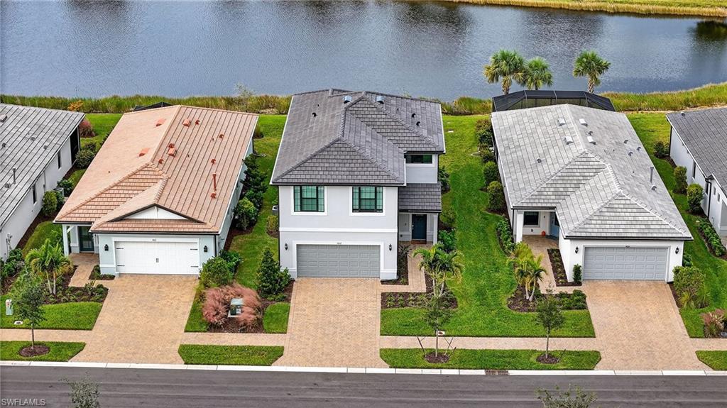 1657 Serena Avenue Naples, FL 34120 - Photo 28 of 40 a front view of a house with a garden