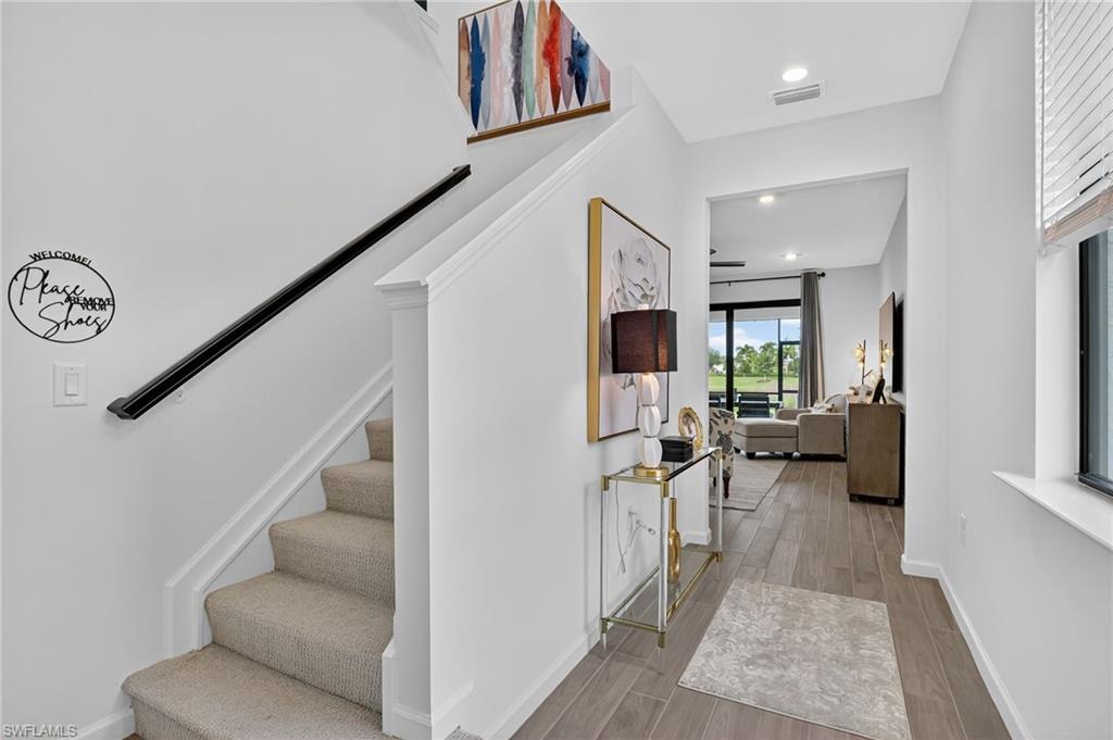 1657 Serena Avenue Naples, FL 34120 - Photo 3 of 40 a view of a hallway view with living room and furniture