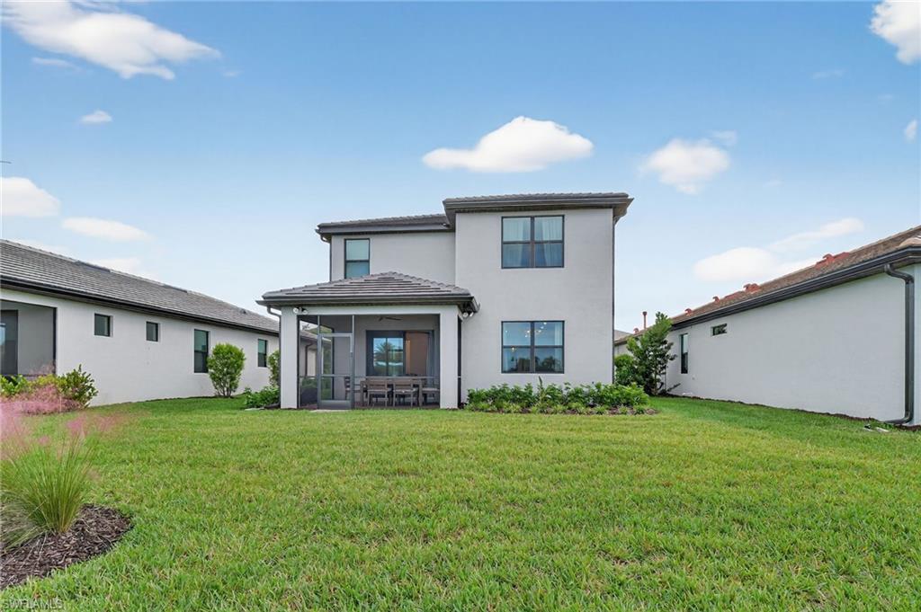 1657 Serena Avenue Naples, FL 34120 - Photo 29 of 40 a front view of a house with garden