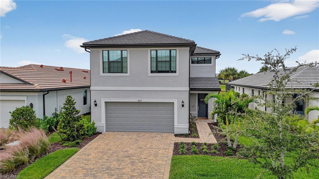 1657 Serena Avenue Naples, FL 34120 - Photo 31 of 40 a front view of a house with a garden