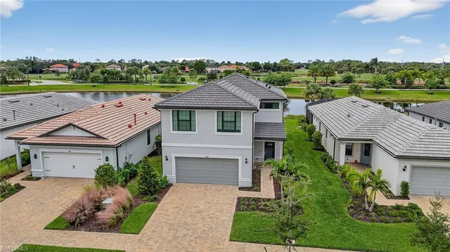 an aerial view of a house with swimming pool and yard