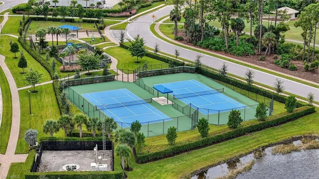 an aerial view of a golf course with swimming pool and outdoor seating