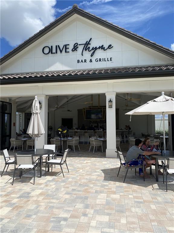 1657 Serena Avenue Naples, FL 34120 - Photo 36 of 40 a group of people sitting in living room